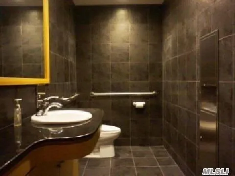 Bathroom with tile walls and tile patterned floors Bathroom with tile walls and tile patterned floors