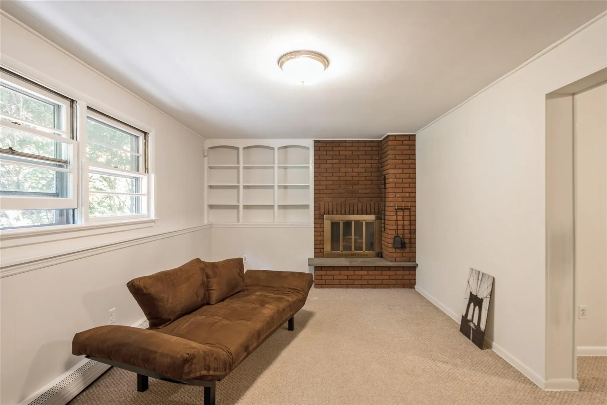 Carpeted basement with fireplace Carpeted basement with fireplace