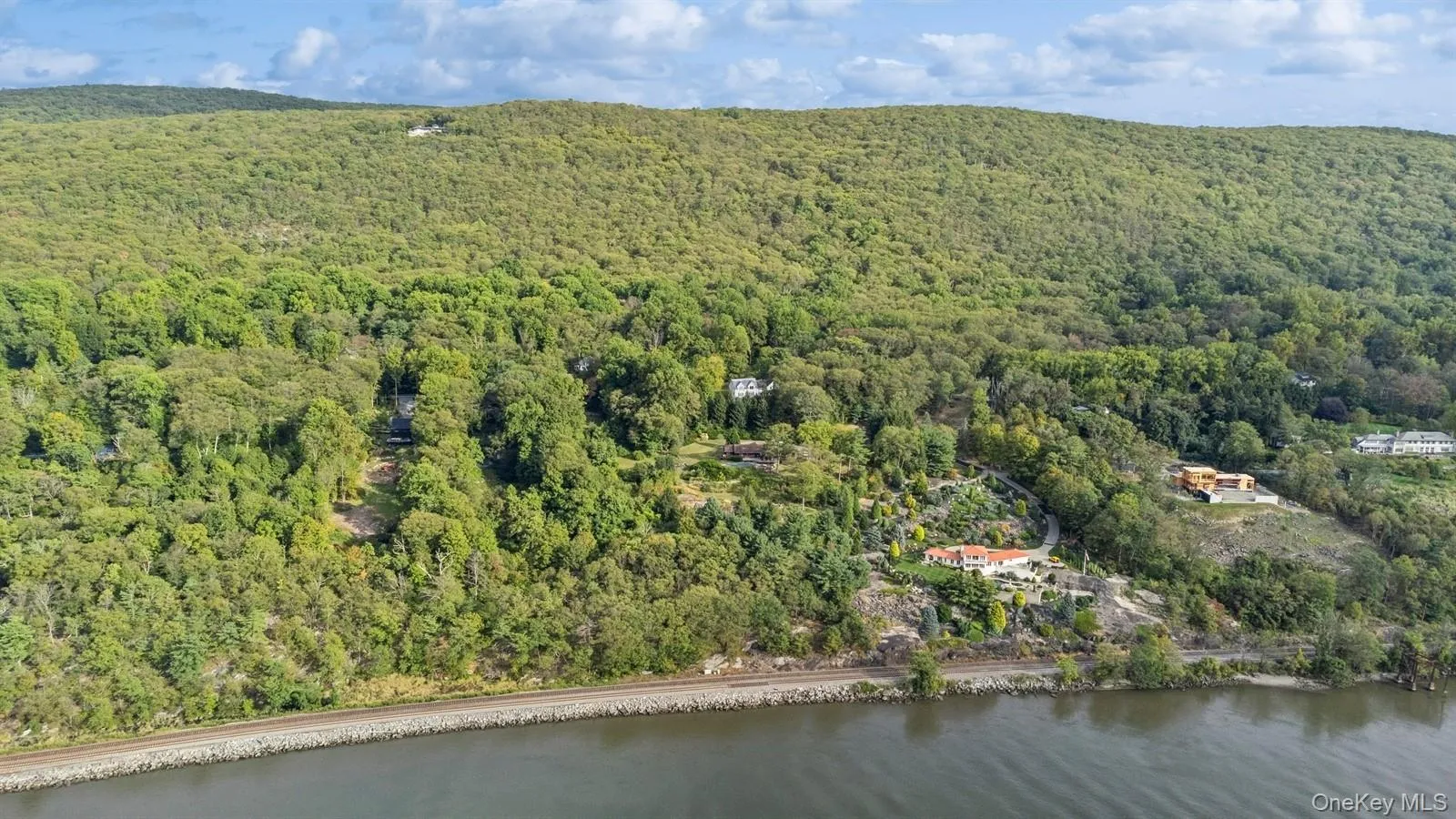 View of property location featuring a forest and a large body of water View of property location featuring a forest and a large body of water