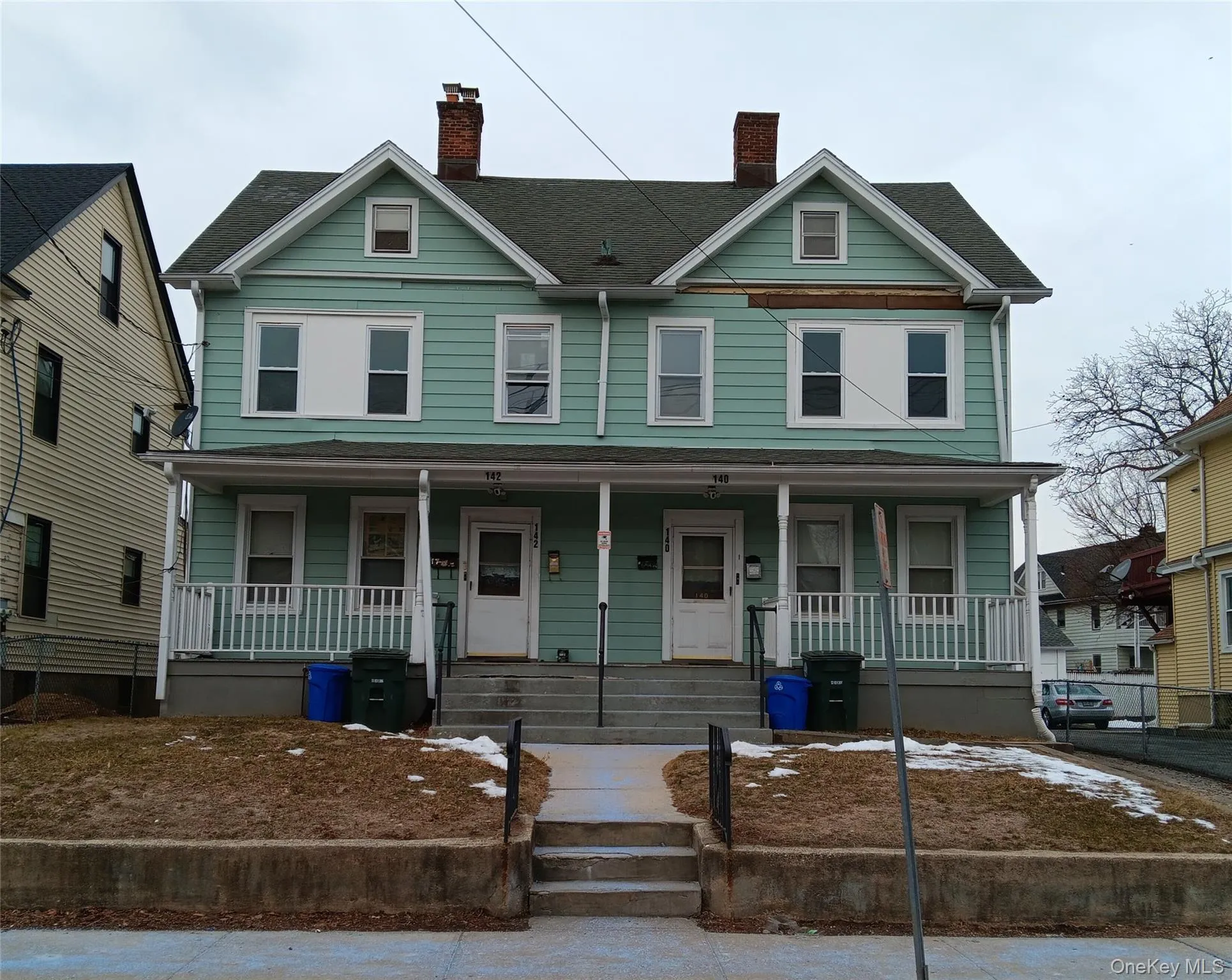 View of front facade featuring a porch, a chimney, and roof with shingles View of front facade featuring a porch, a chimney, and roof with shingles