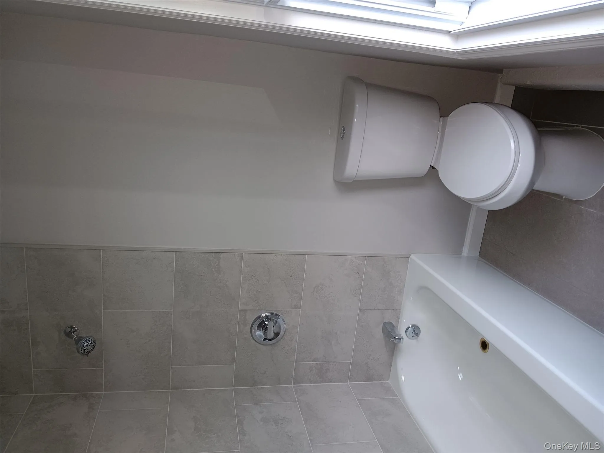 Full bathroom with shower / bath combination and tile patterned floors Full bathroom with shower / bath combination and tile patterned floors