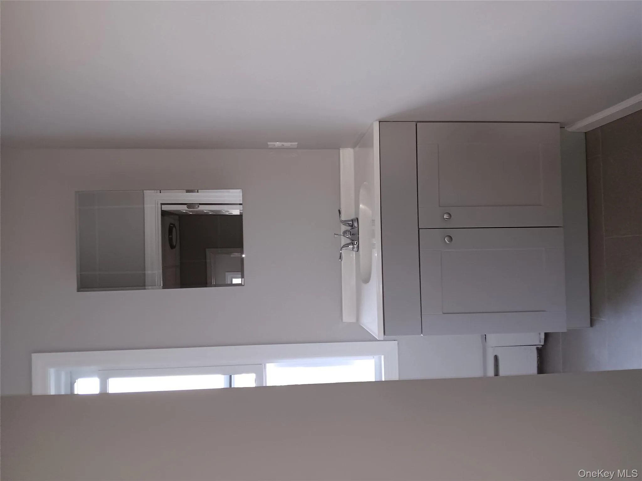 Bathroom with plenty of natural light, vanity, tile patterned floors, and a baseboard radiator Bathroom with plenty of natural light, vanity, tile patterned floors, and a baseboard radiator