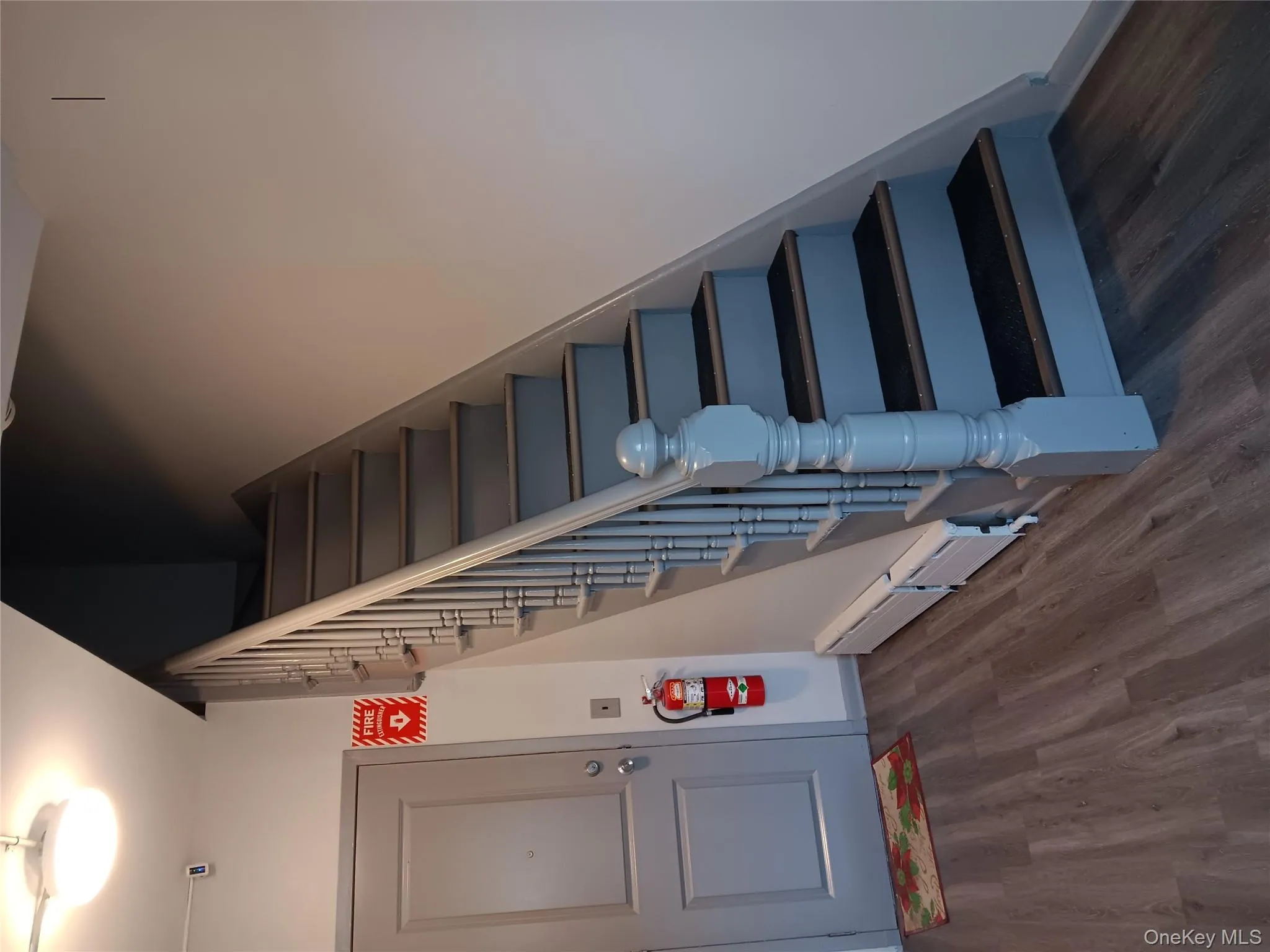 Staircase with wood finished floors and a baseboard radiator Staircase with wood finished floors and a baseboard radiator