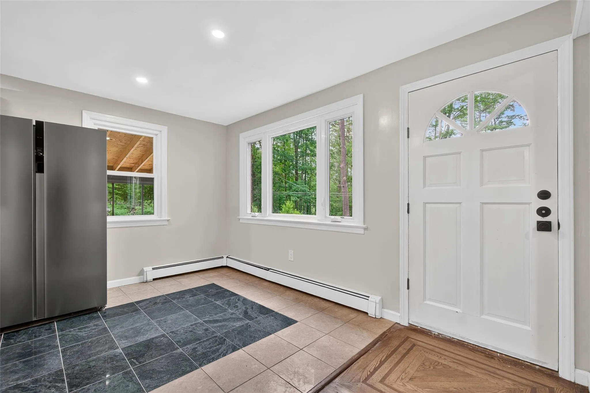 Foyer with a baseboard radiator and recessed lighting Foyer with a baseboard radiator and recessed lighting