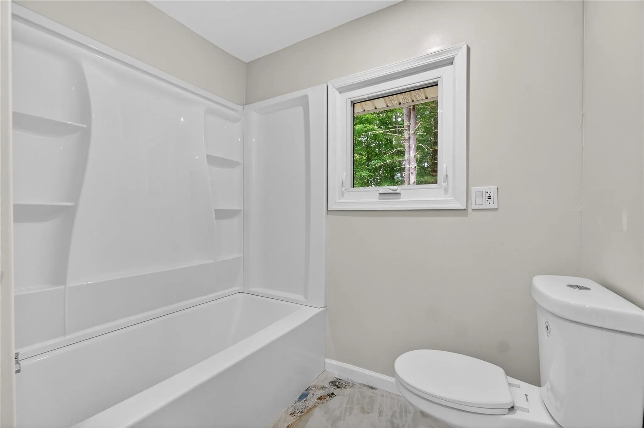 Bathroom featuring toilet and shower combination Bathroom featuring toilet and shower combination