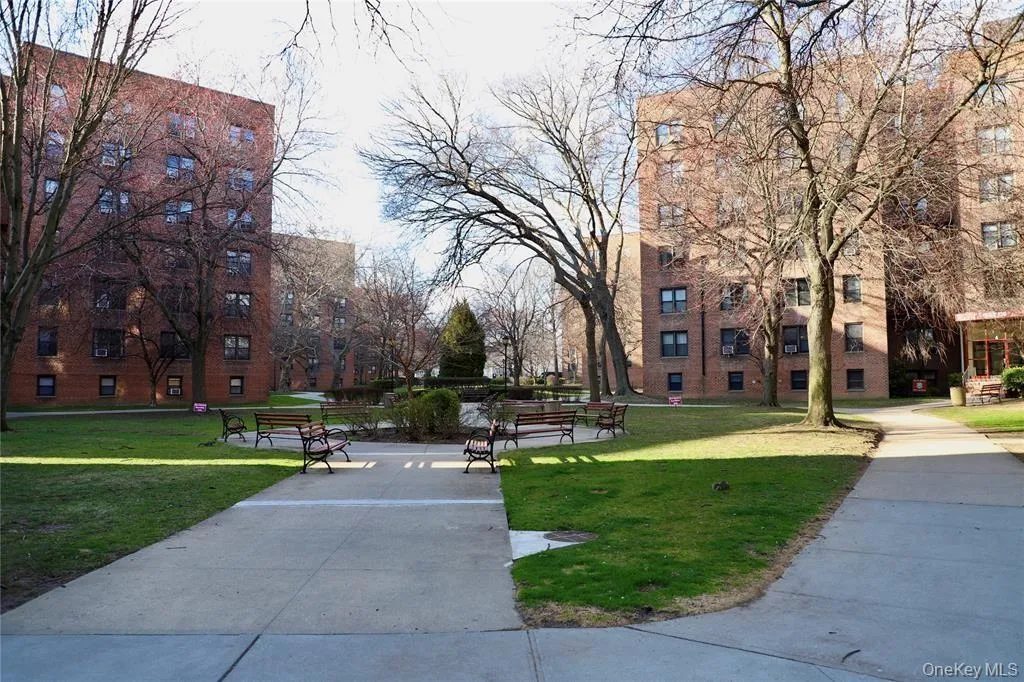 View of property's community with a lawn View of property's community with a lawn