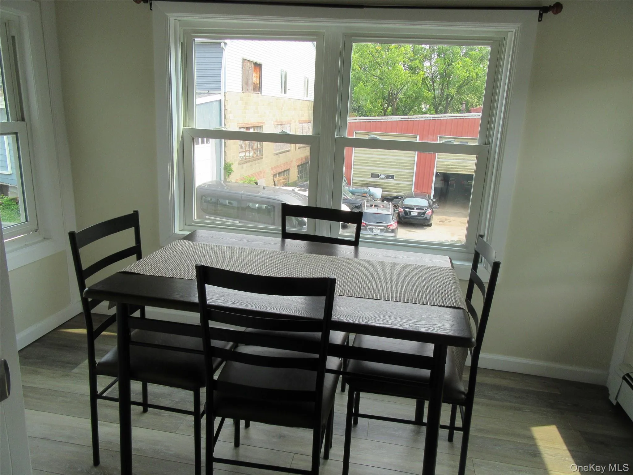 Dining area featuring baseboards and wood finished floors Dining area featuring baseboards and wood finished floors