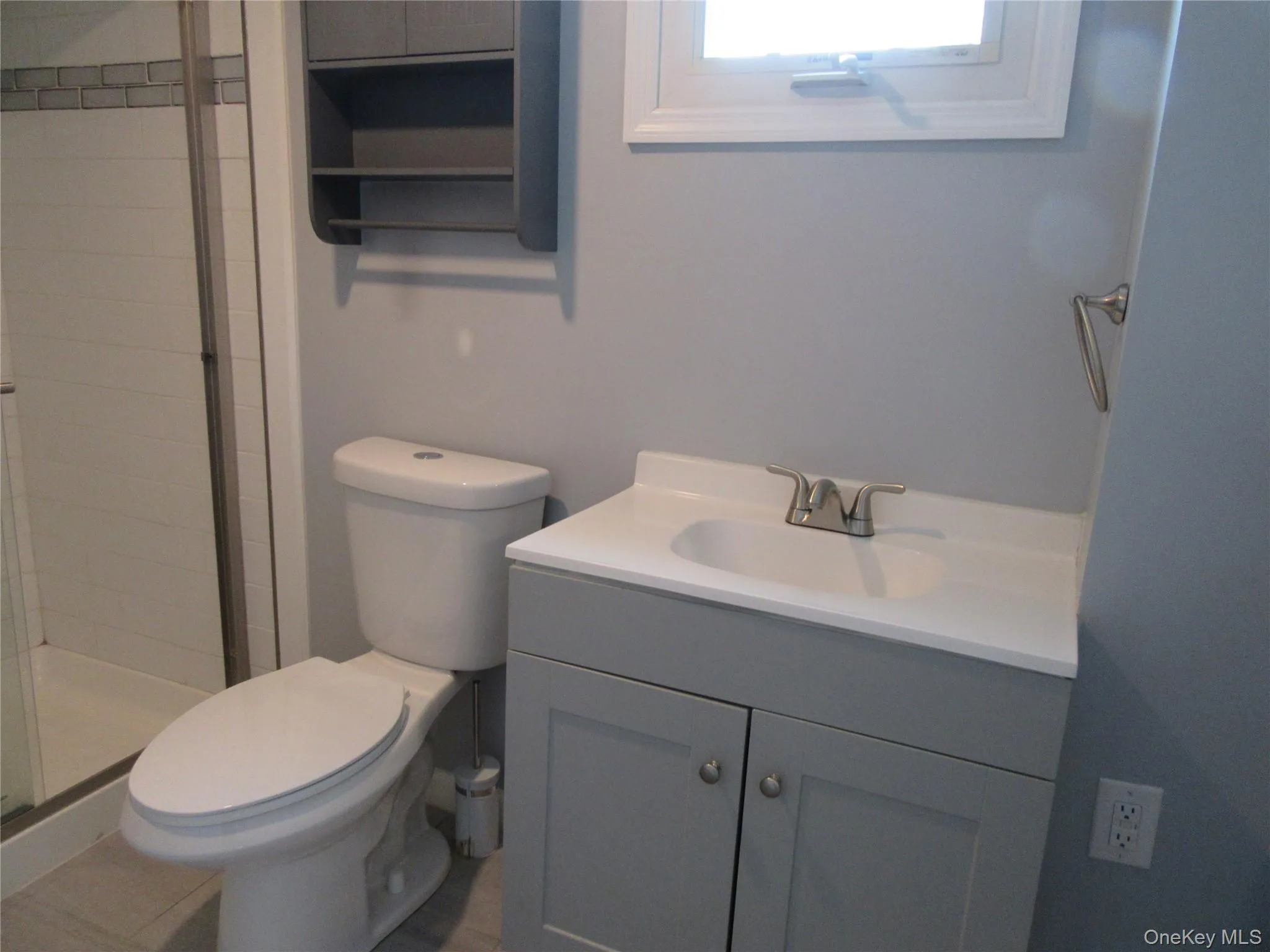 Bathroom with vanity and a stall shower Bathroom with vanity and a stall shower