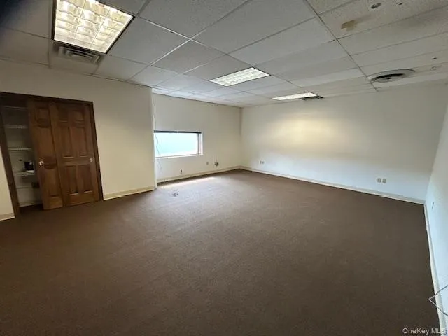 Spare room with a drop ceiling and carpet Spare room with a drop ceiling and carpet