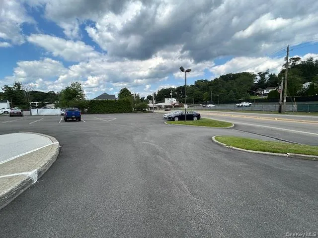 View of road featuring street lights and curbs View of road featuring street lights and curbs