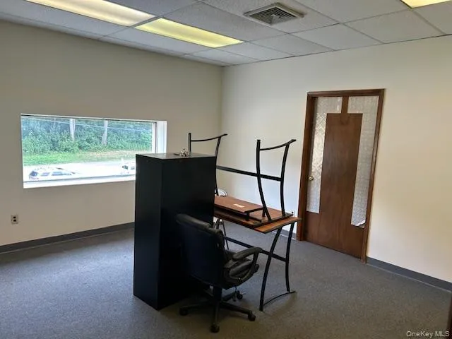 Office space with baseboards and a drop ceiling Office space with baseboards and a drop ceiling