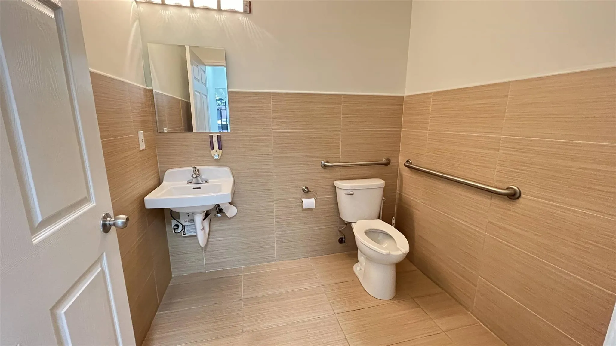 Bathroom with tile walls and tile patterned floors Bathroom with tile walls and tile patterned floors