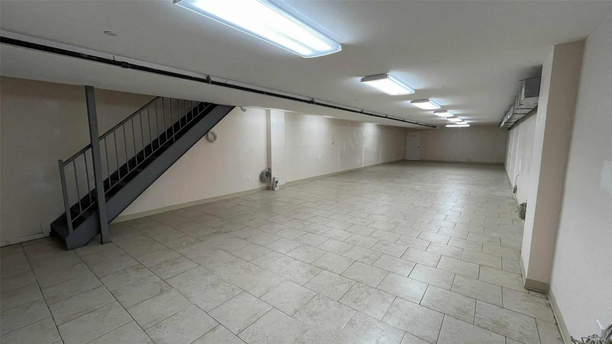 Finished basement with stairway and baseboards Finished basement with stairway and baseboards