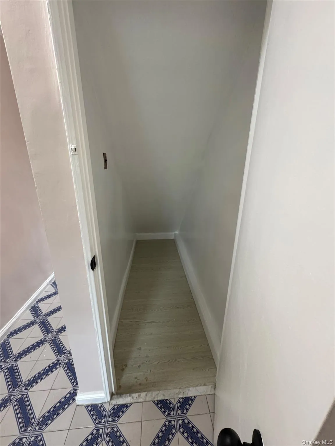 Stairway with tile patterned floors and baseboards Stairway with tile patterned floors and baseboards