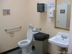 Half bathroom with toilet and a sink Half bathroom with toilet and a sink