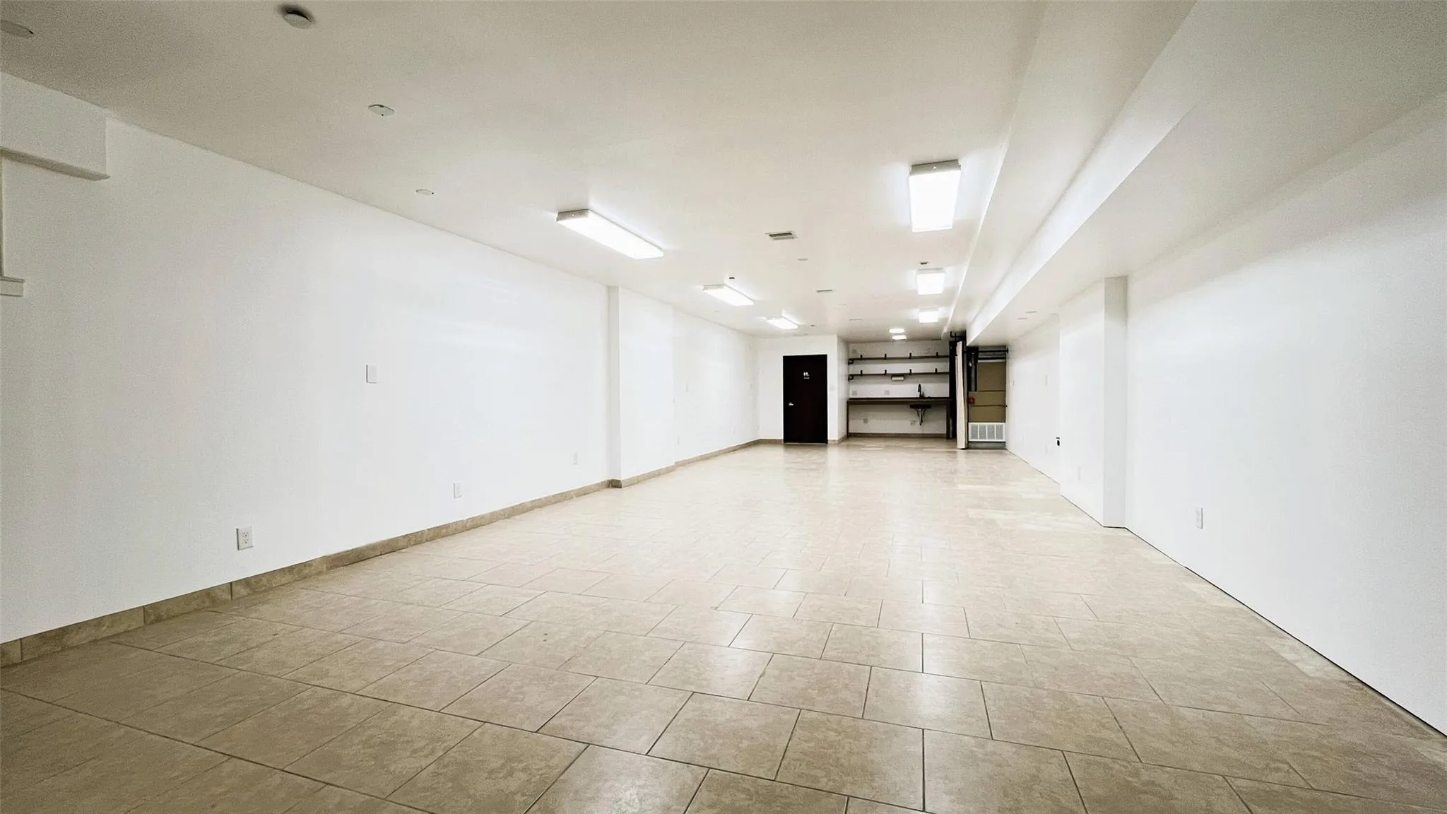 Spare room featuring light tile patterned floors and baseboards Spare room featuring light tile patterned floors and baseboards