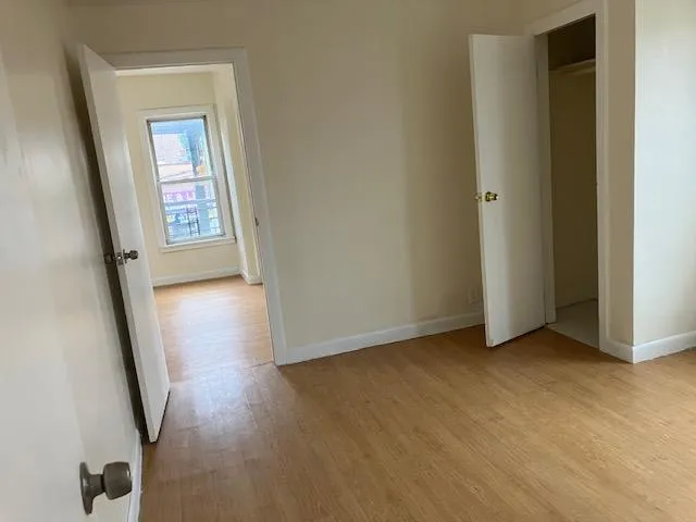 Unfurnished bedroom featuring light wood finished floors and baseboards Unfurnished bedroom featuring light wood finished floors and baseboards