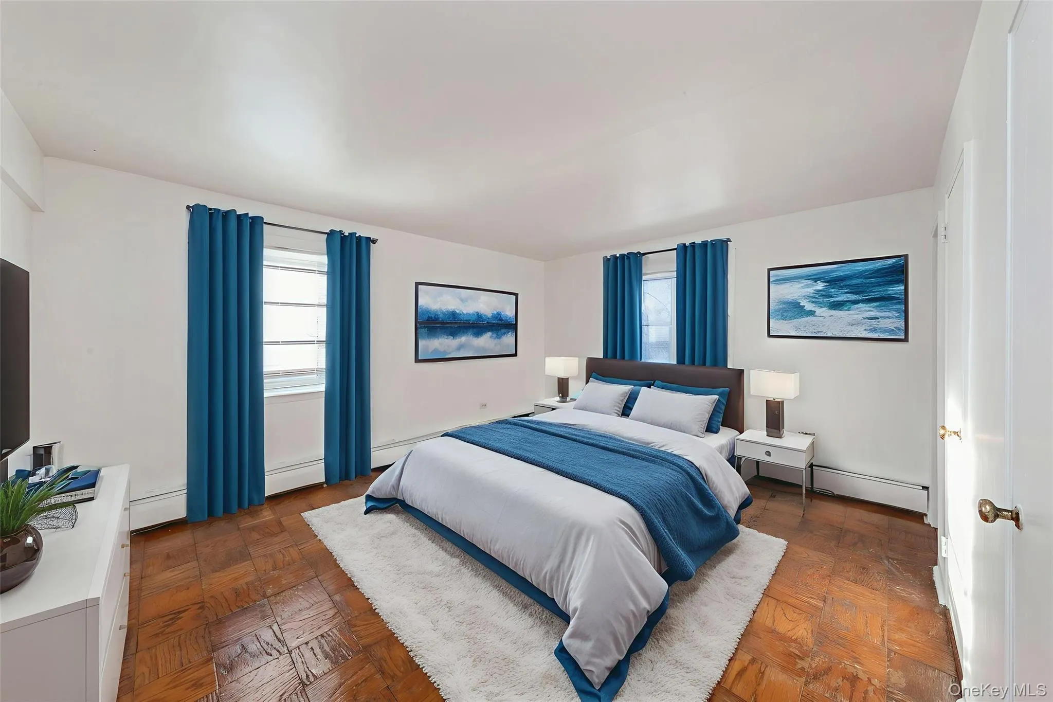 Bedroom featuring multiple windows, a baseboard heating unit, and baseboard heating Bedroom featuring multiple windows, a baseboard heating unit, and baseboard heating