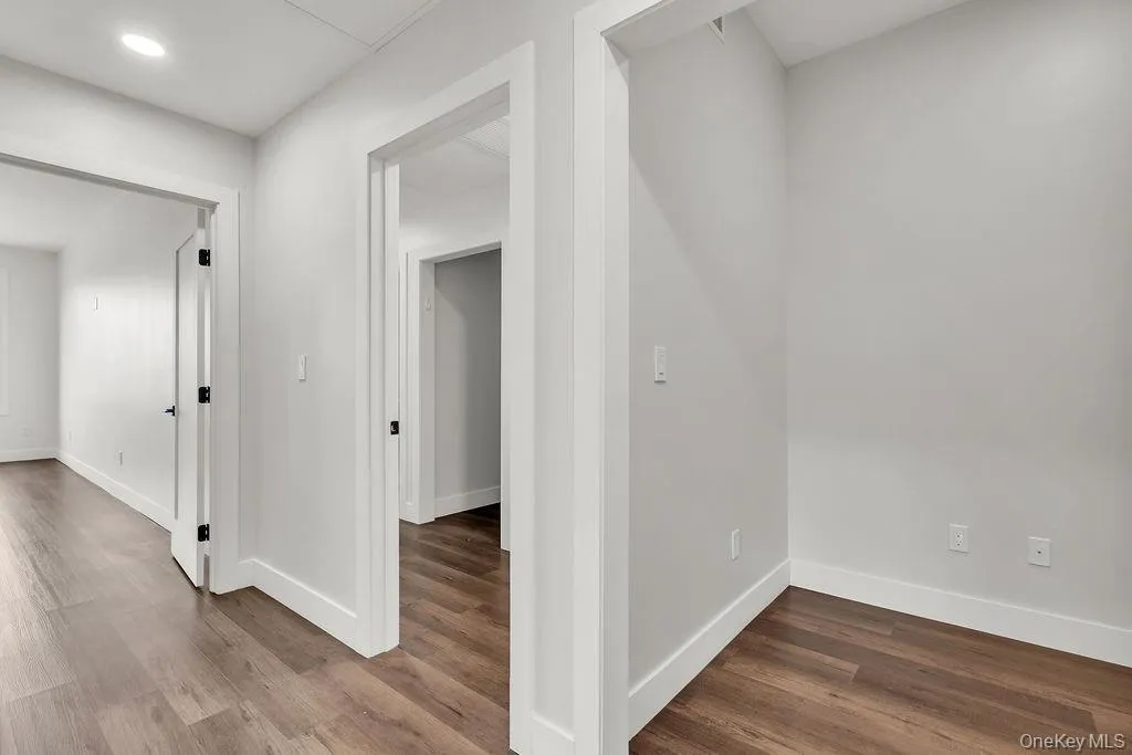 Hall featuring wood finished floors and recessed lighting Hall featuring wood finished floors and recessed lighting
