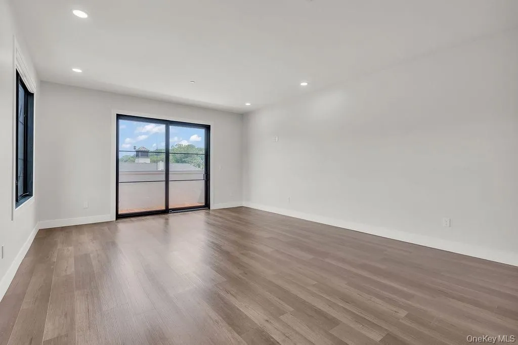 Unfurnished room featuring wood finished floors and recessed lighting Unfurnished room featuring wood finished floors and recessed lighting