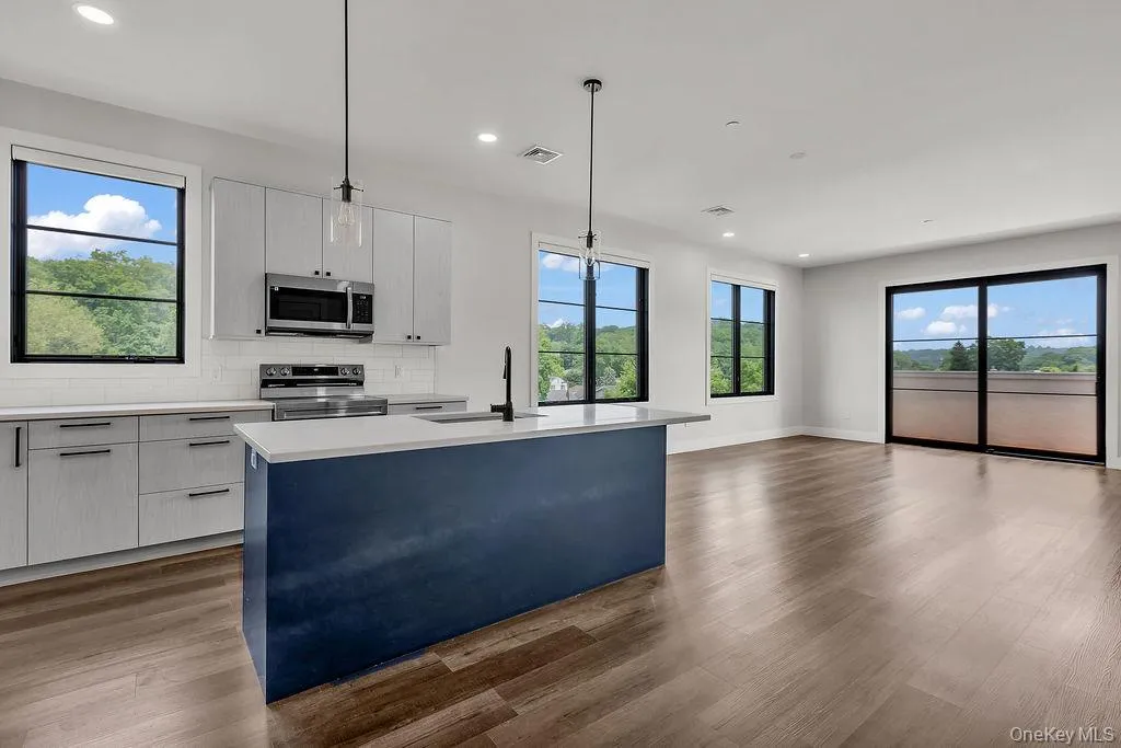 Kitchen with healthy amount of natural light, light countertops, electric stove, and recessed lighting Kitchen with healthy amount of natural light, light countertops, electric stove, and recessed lighting