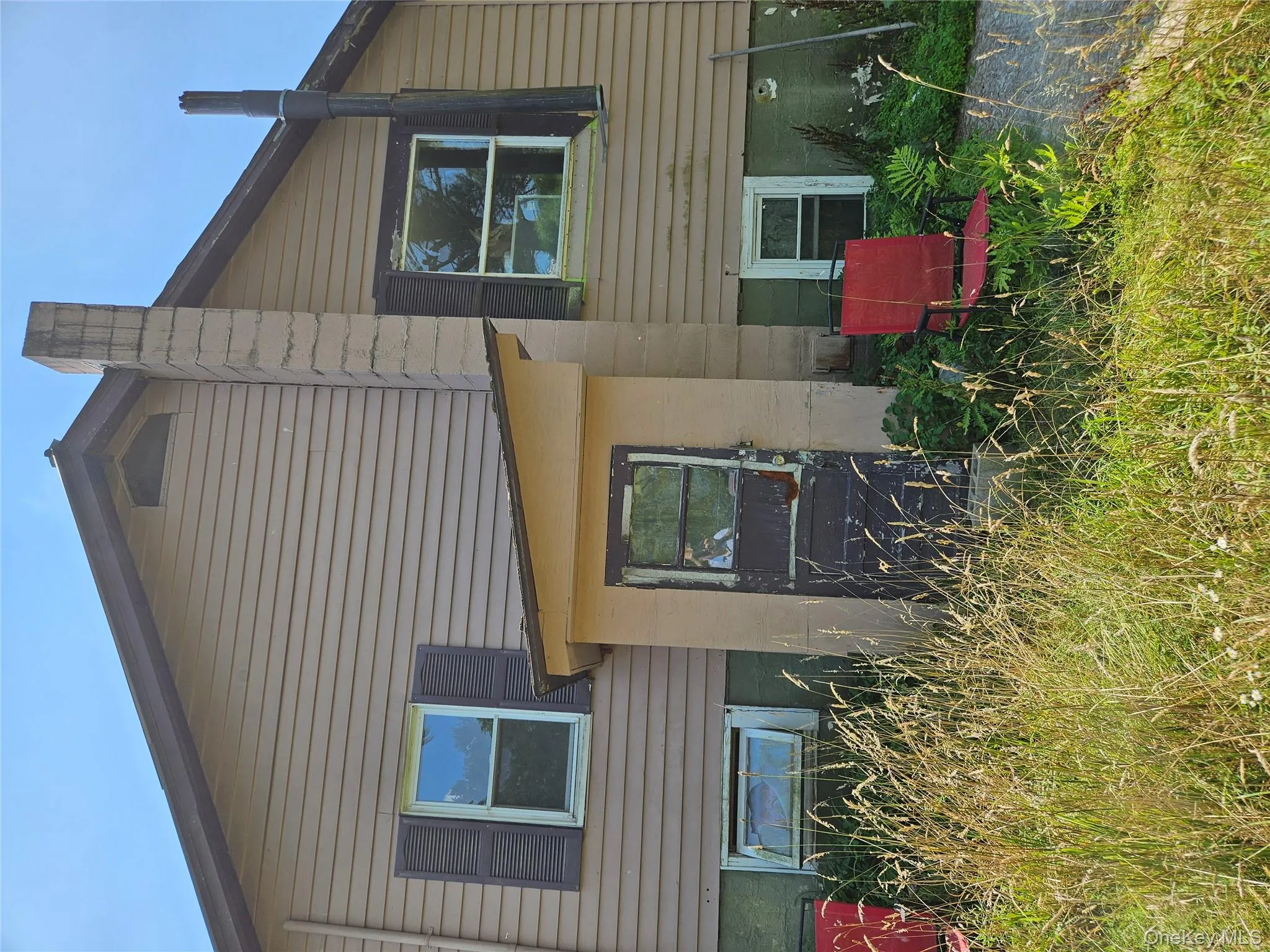 Back of house with a chimney Back of house with a chimney