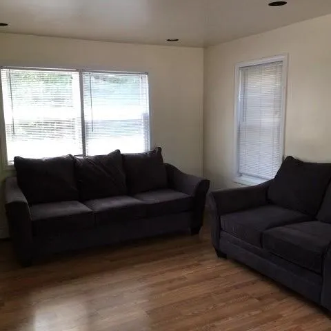 Living room featuring a wealth of natural light and hardwood / wood-style flooring Living room featuring a wealth of natural light and hardwood / wood-style flooring
