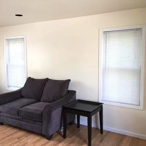 Living room with hardwood / wood-style flooring Living room with hardwood / wood-style flooring