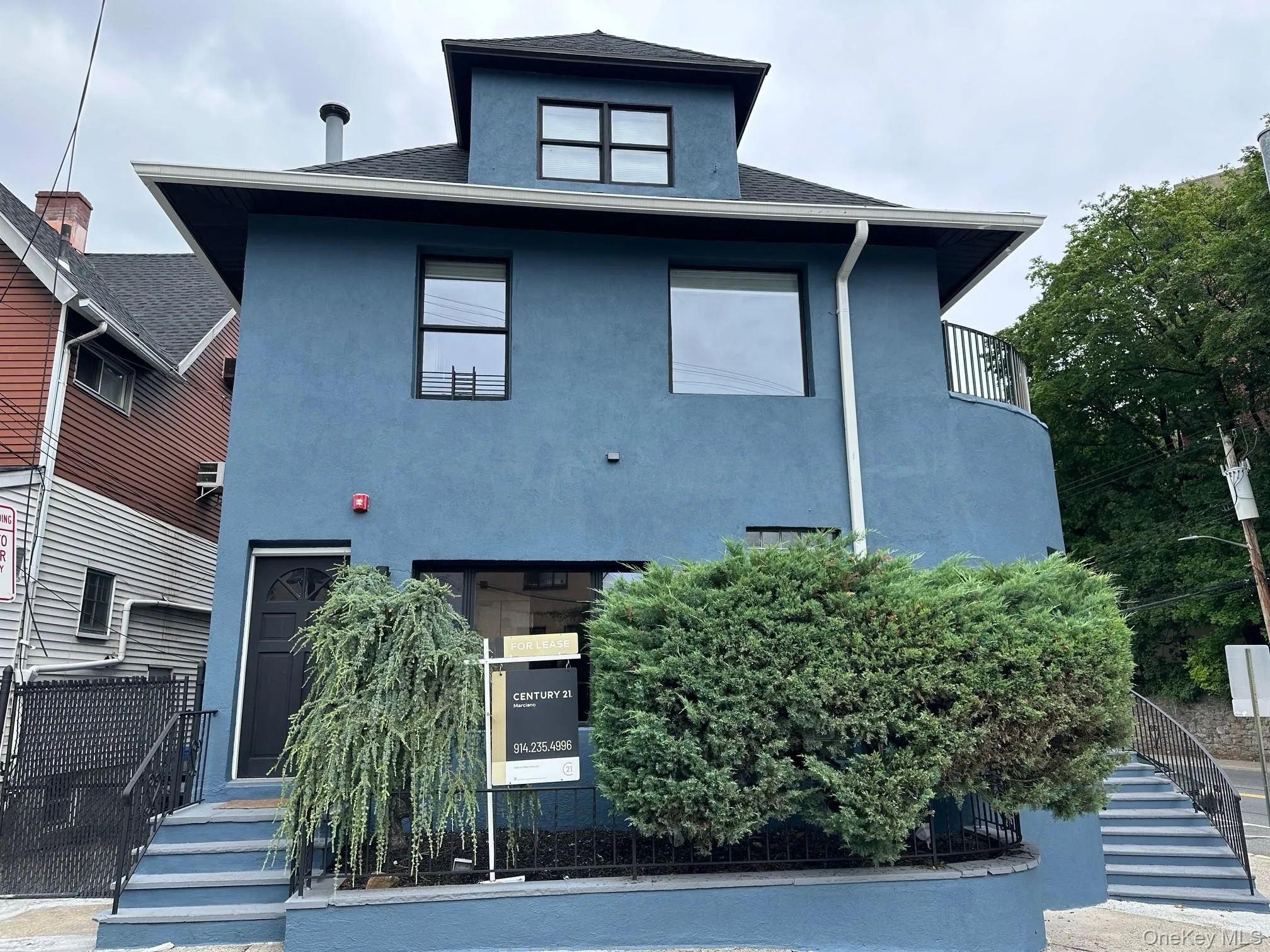 View of front of house featuring stucco siding, stairway, a balcony, and a shingled roof View of front of house featuring stucco siding, stairway, a balcony, and a shingled roof