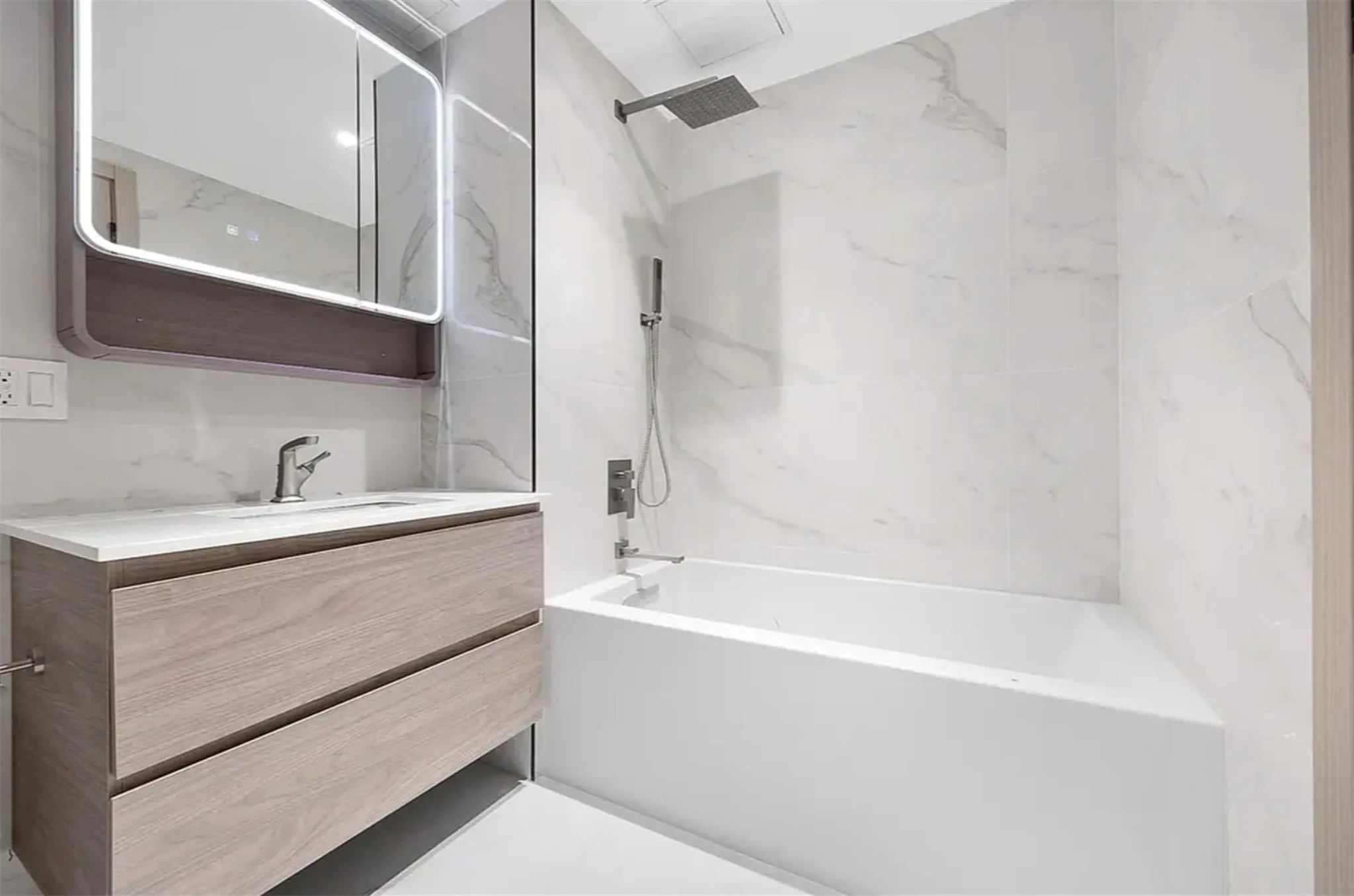Full bath with vanity, tub / shower combination, and tile walls Full bath with vanity, tub / shower combination, and tile walls