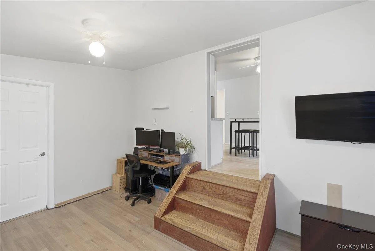 Office space featuring ceiling fan and light wood-style floors Office space featuring ceiling fan and light wood-style floors