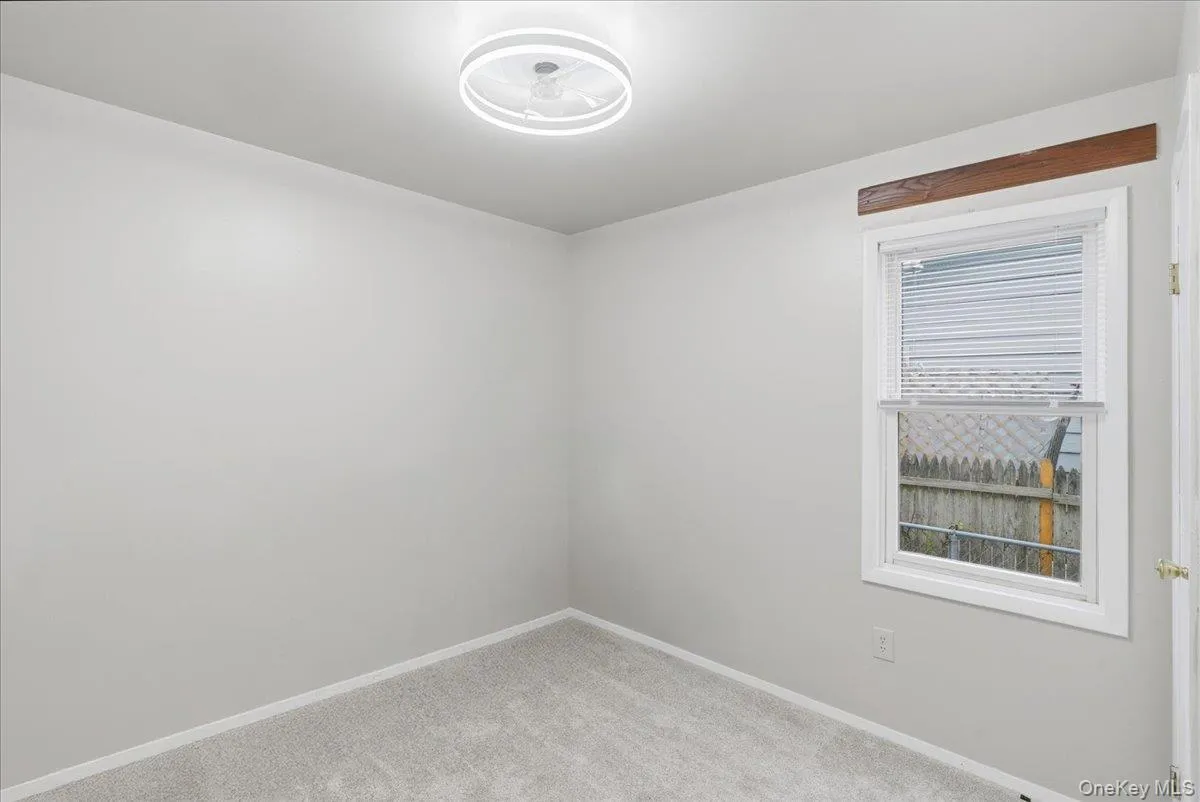 Carpeted empty room featuring baseboards Carpeted empty room featuring baseboards