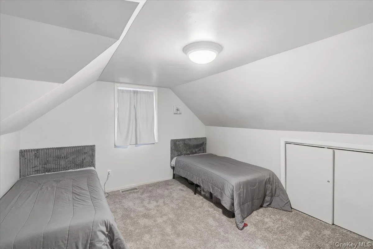 Bedroom with lofted ceiling and carpet Bedroom with lofted ceiling and carpet