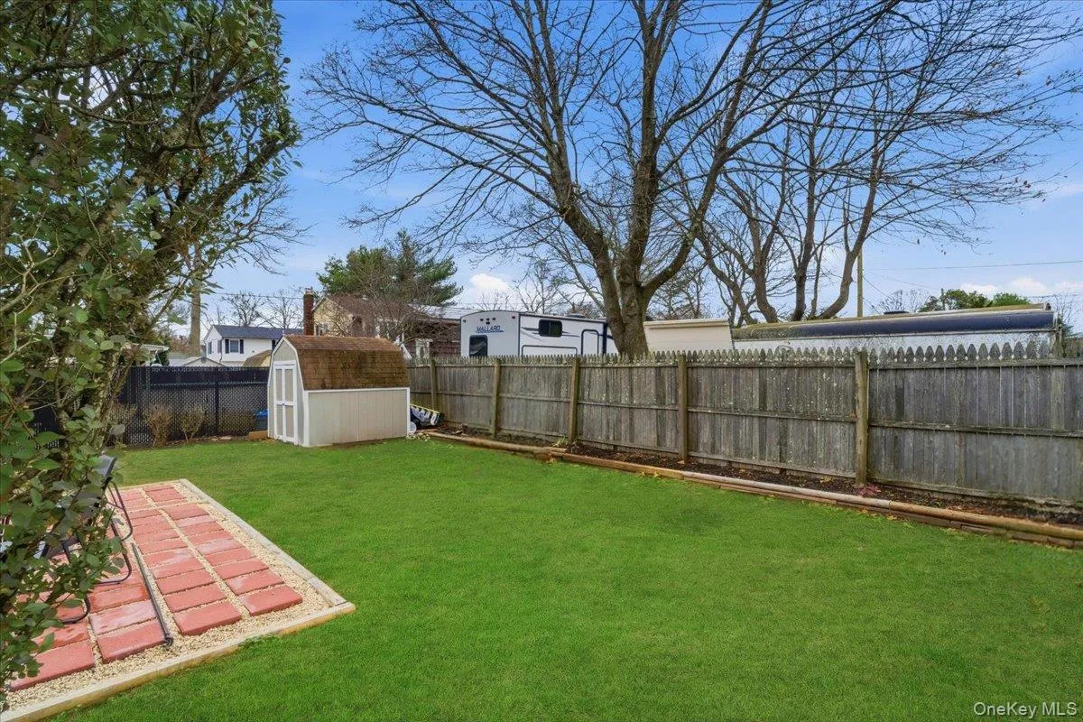 Fenced backyard with a shed Fenced backyard with a shed