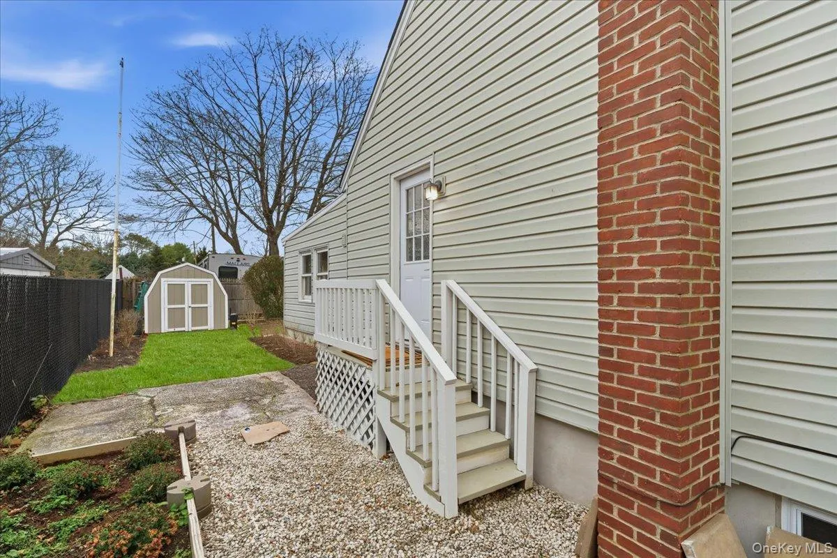 Fenced backyard with a storage shed Fenced backyard with a storage shed