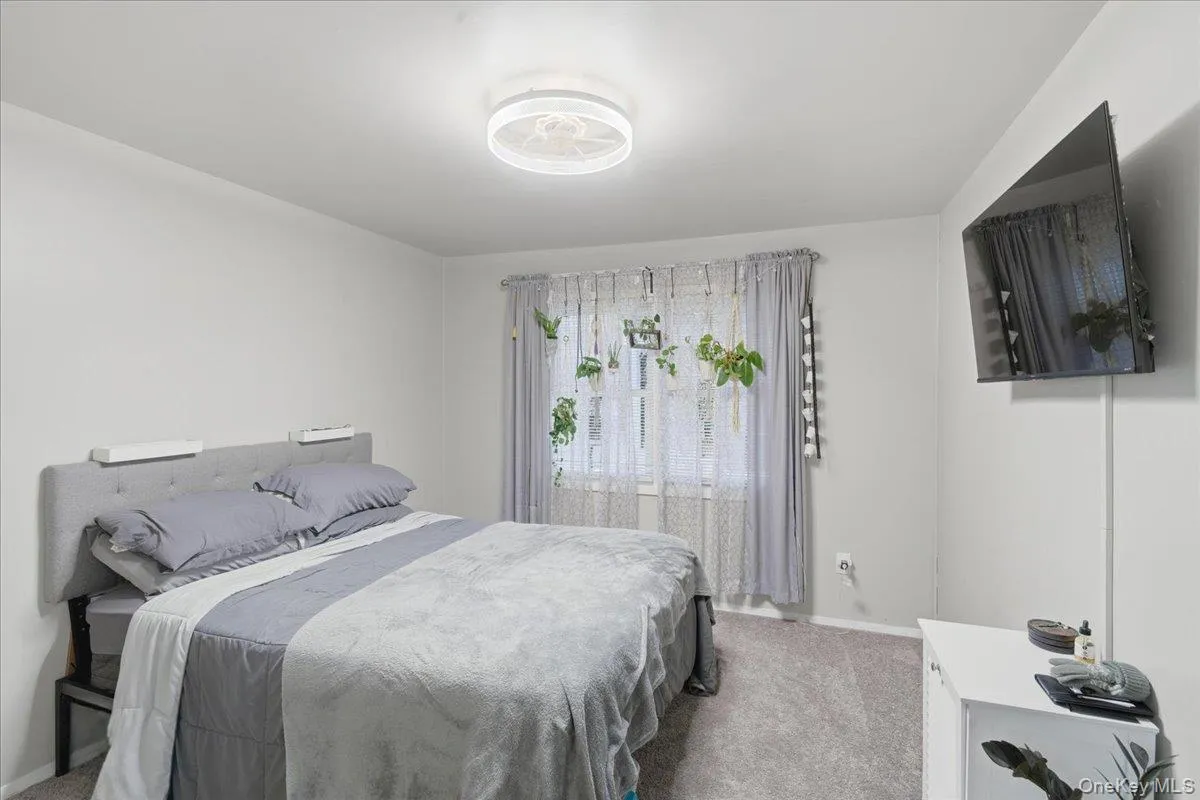 Carpeted bedroom with baseboards Carpeted bedroom with baseboards