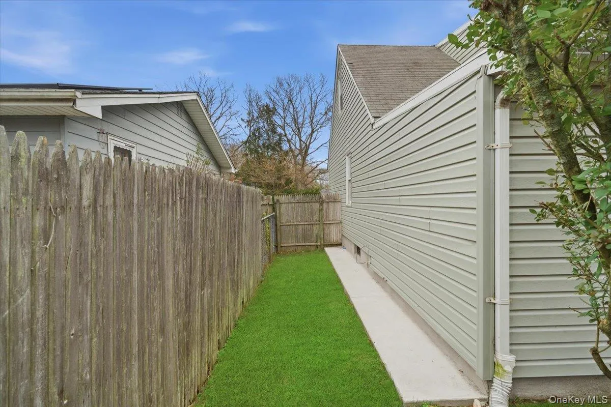 View of home's exterior with a shingled roof View of home's exterior with a shingled roof