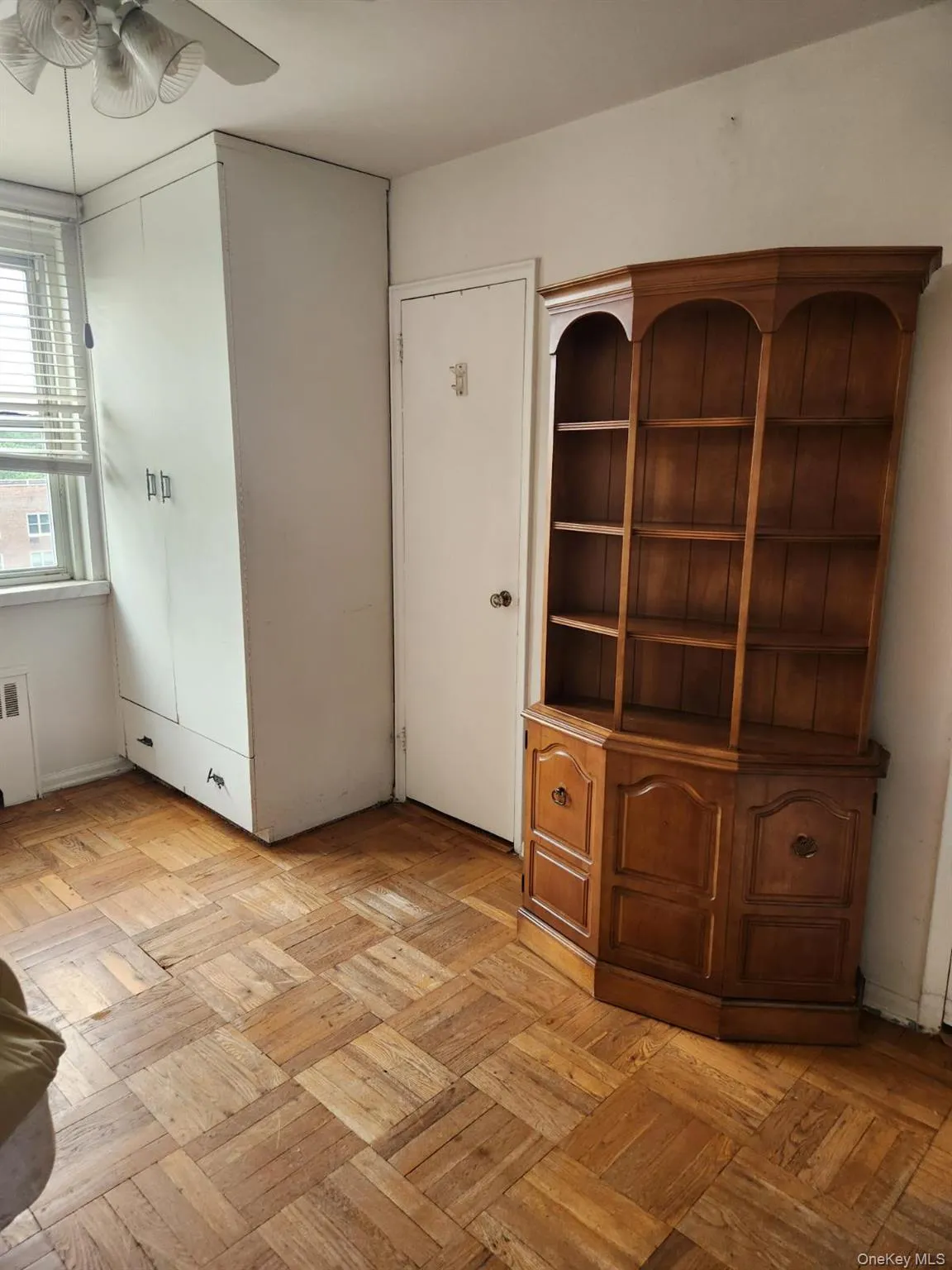 Unfurnished office with a ceiling fan and radiator Unfurnished office with a ceiling fan and radiator