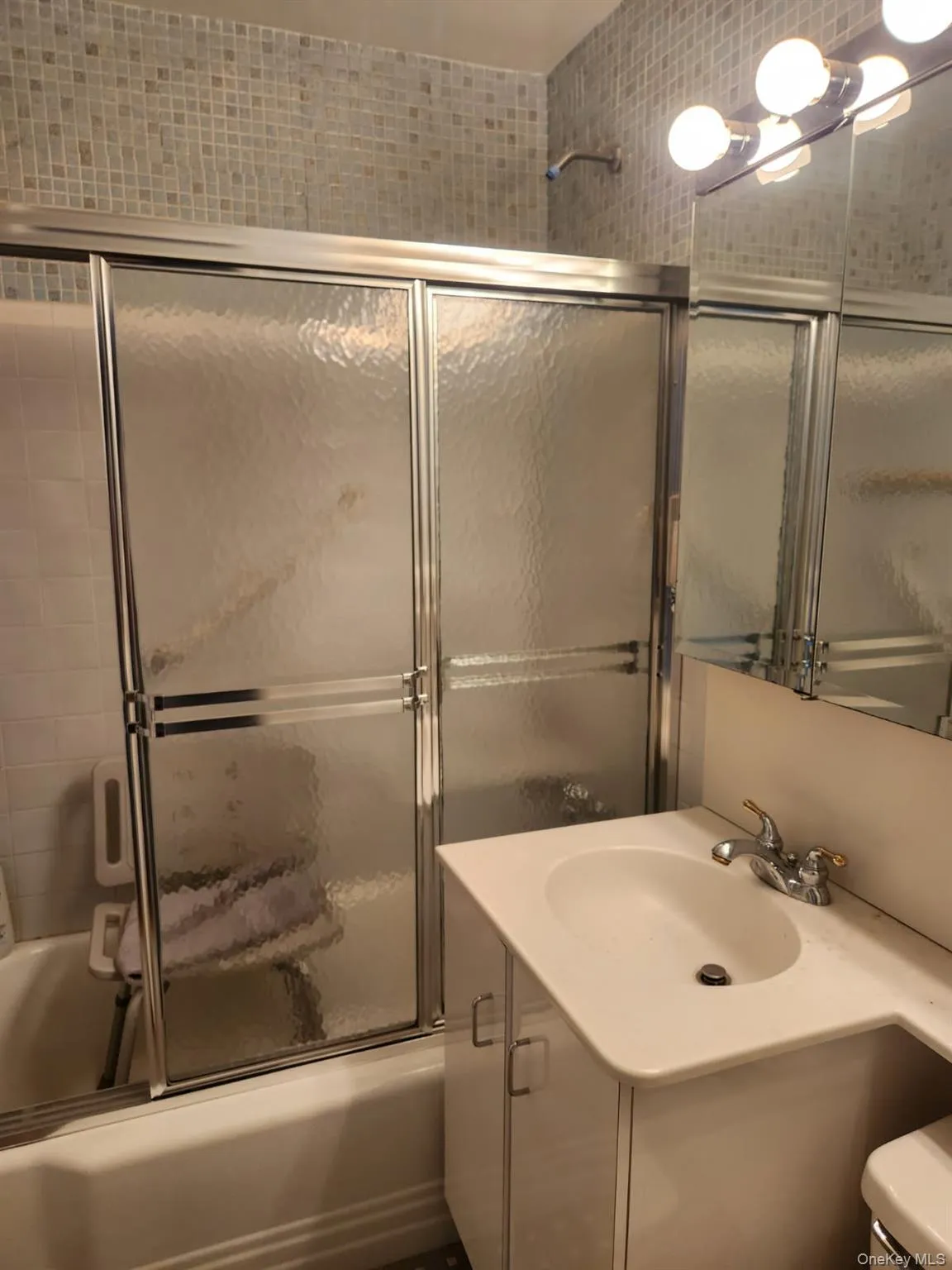Bathroom with vanity and bath / shower combo with glass door Bathroom with vanity and bath / shower combo with glass door
