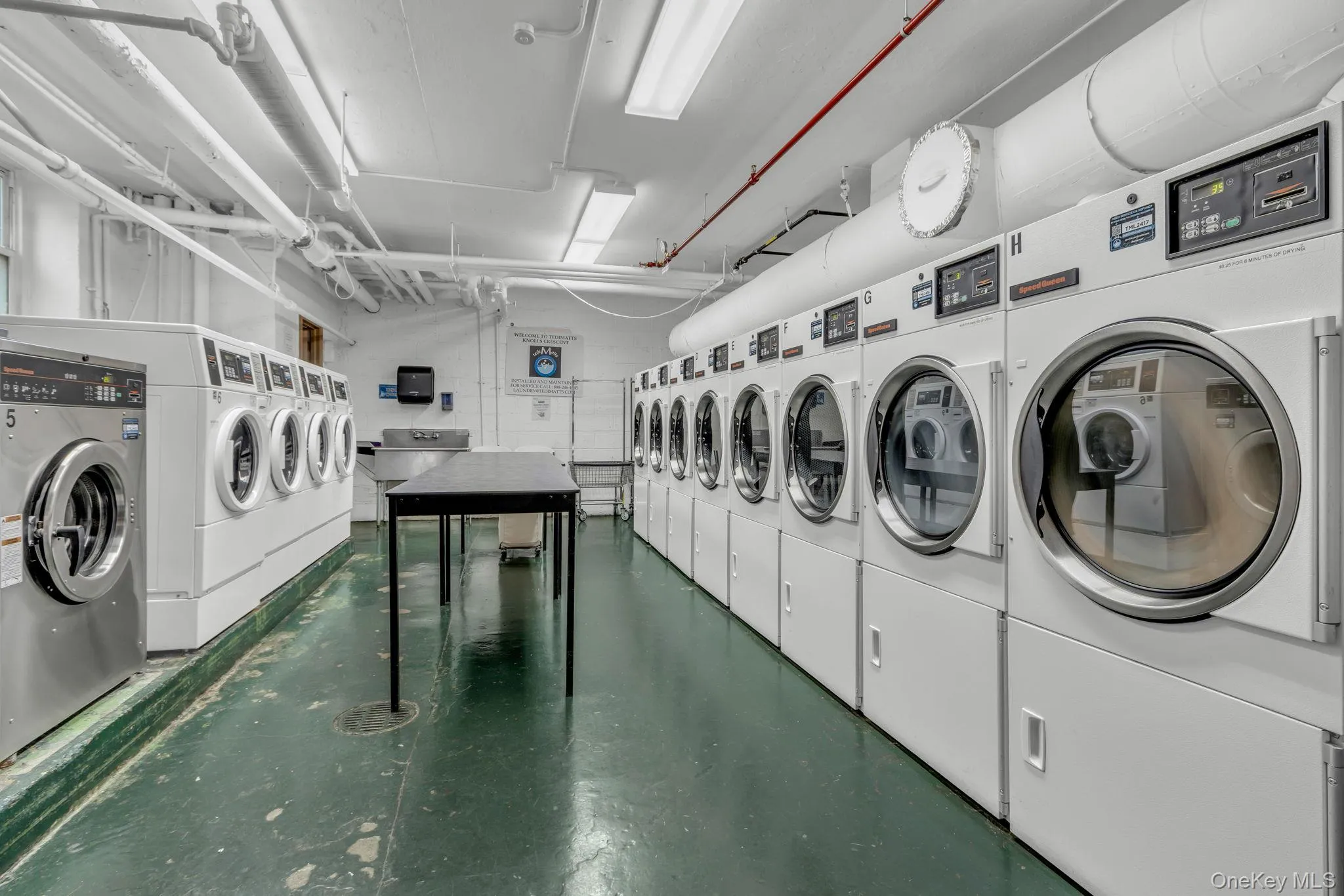 Shared laundry room featuring separate washer and dryer Shared laundry room featuring separate washer and dryer