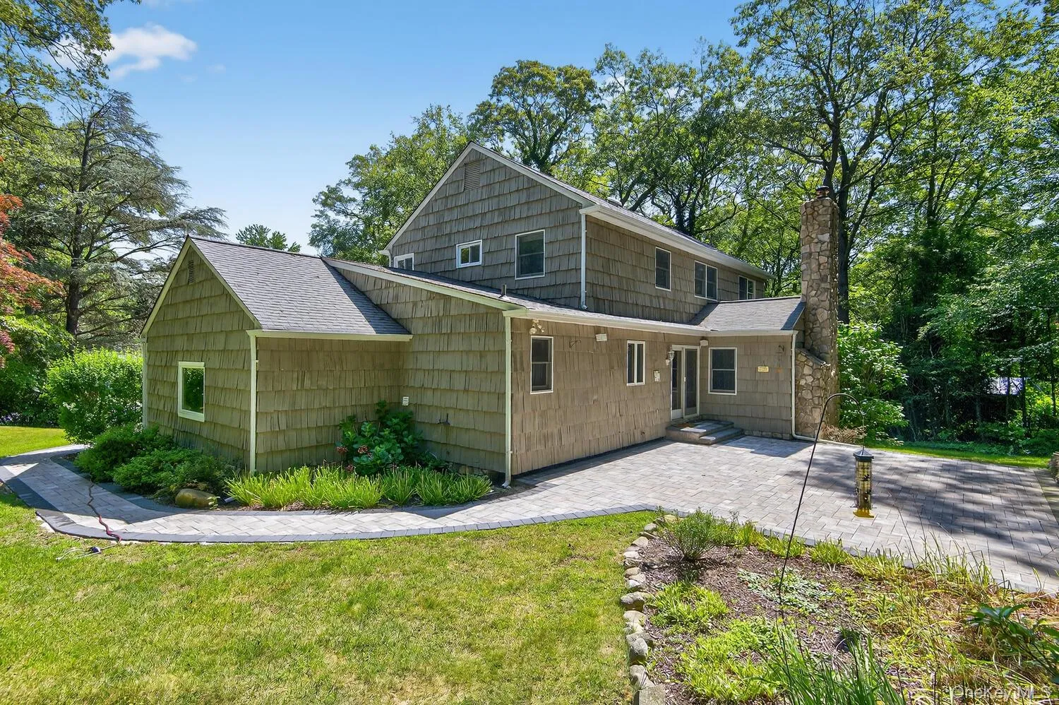 Back of property featuring roof with shingles, a yard, a chimney, and a patio area Back of property featuring roof with shingles, a yard, a chimney, and a patio area