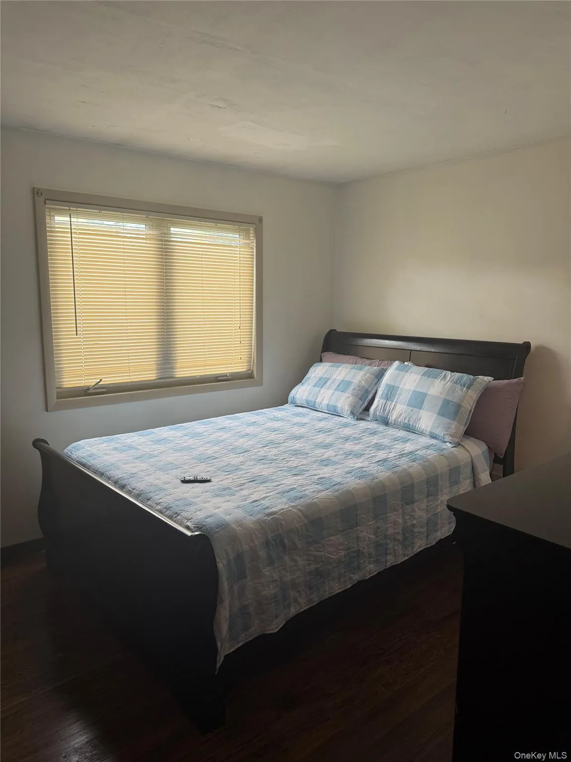 Bedroom featuring dark wood-style floors Bedroom featuring dark wood-style floors