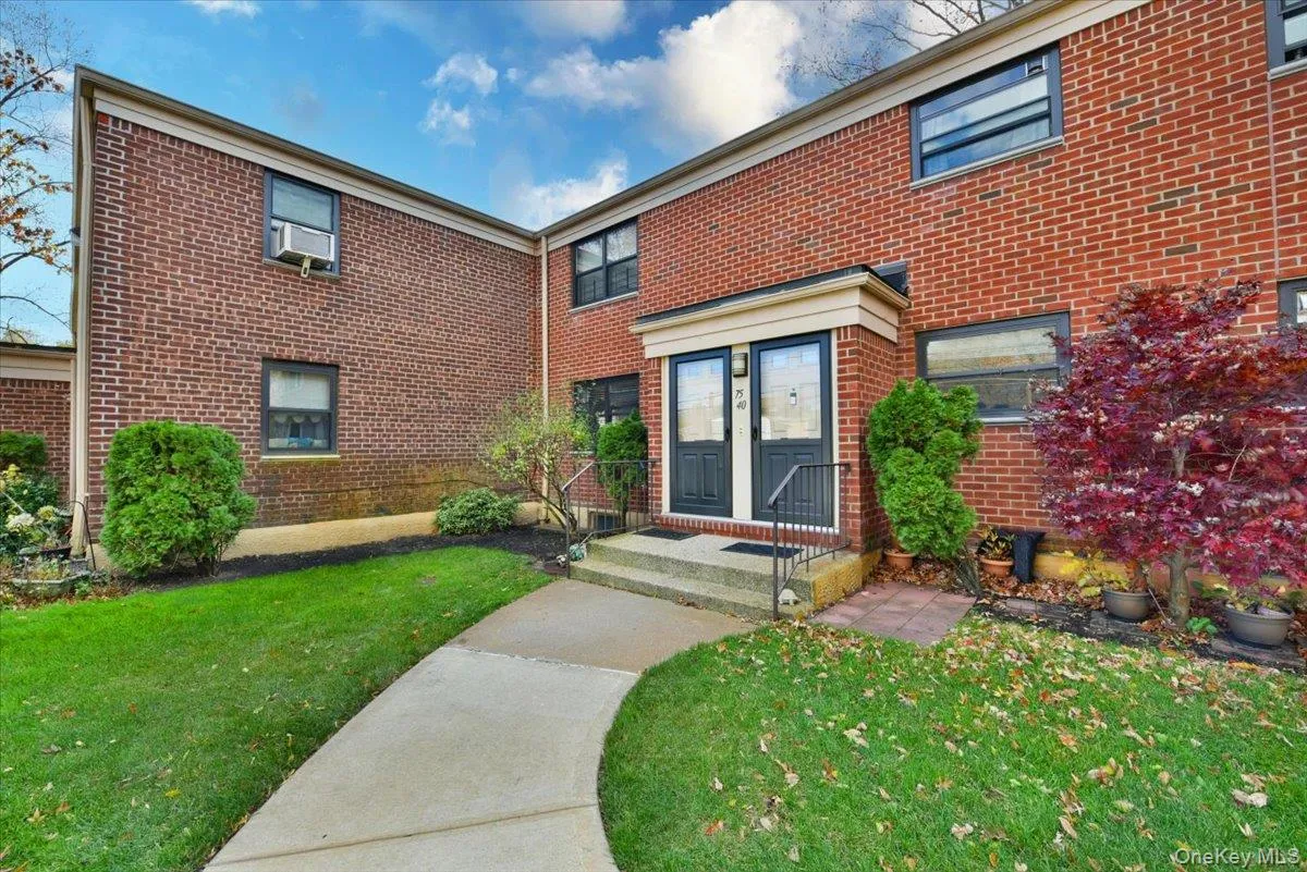 View of front of property featuring brick siding and a front yard View of front of property featuring brick siding and a front yard