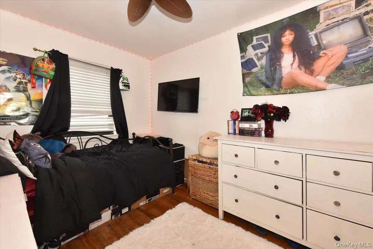 Bedroom featuring light wood-style flooring and ceiling fan Bedroom featuring light wood-style flooring and ceiling fan