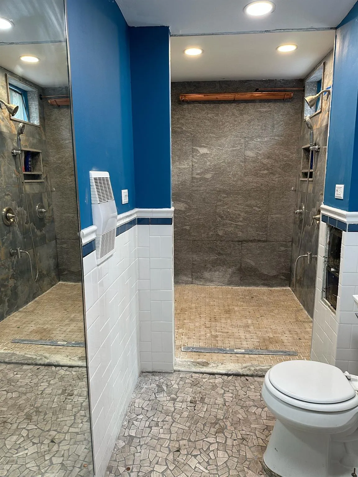 Full bath with recessed lighting, walk in shower, tile walls, a wainscoted wall, and stone finish floors Full bath with recessed lighting, walk in shower, tile walls, a wainscoted wall, and stone finish floors
