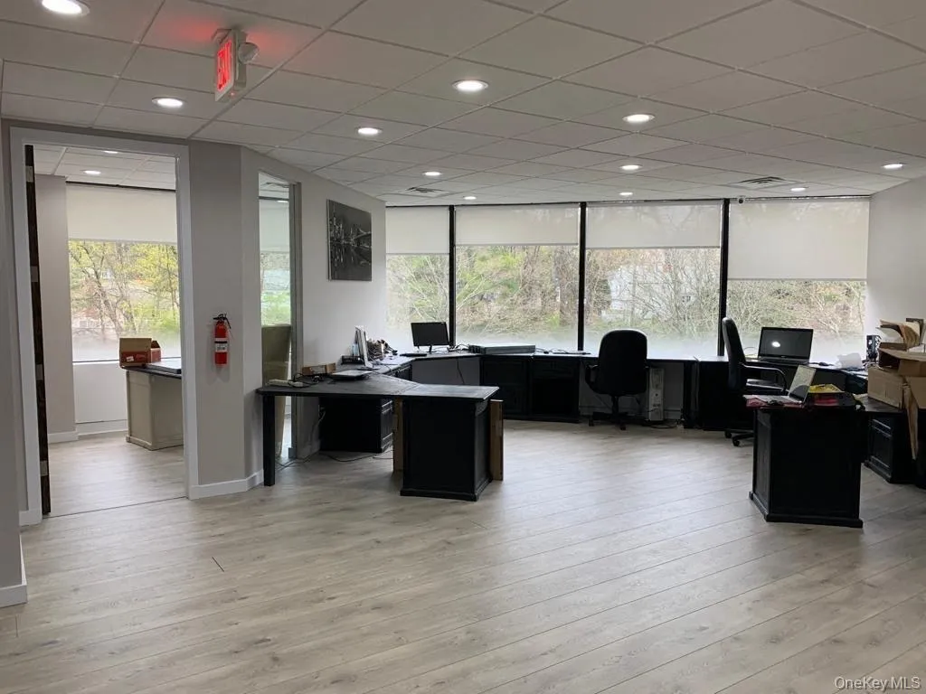 Office area featuring healthy amount of natural light, light wood-style floors, recessed lighting, and a paneled ceiling Office area featuring healthy amount of natural light, light wood-style floors, recessed lighting, and a paneled ceiling