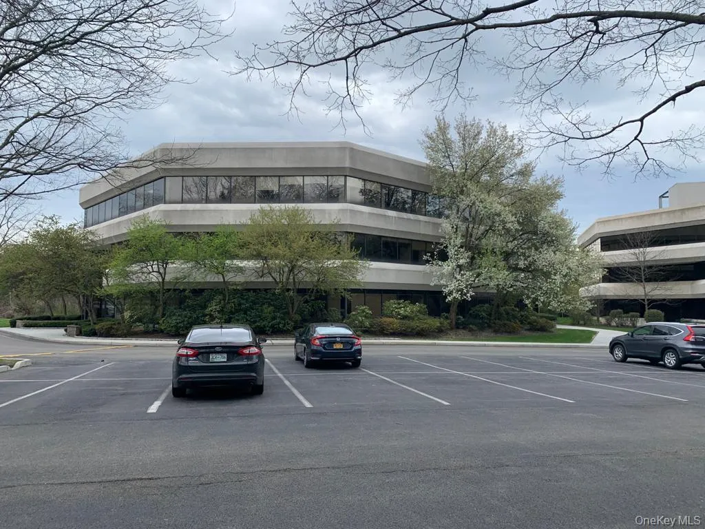 View of building exterior featuring uncovered parking View of building exterior featuring uncovered parking