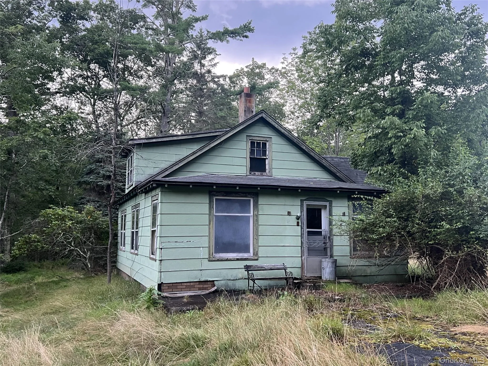 Back of house with roof with shingles and a chimney Back of house with roof with shingles and a chimney