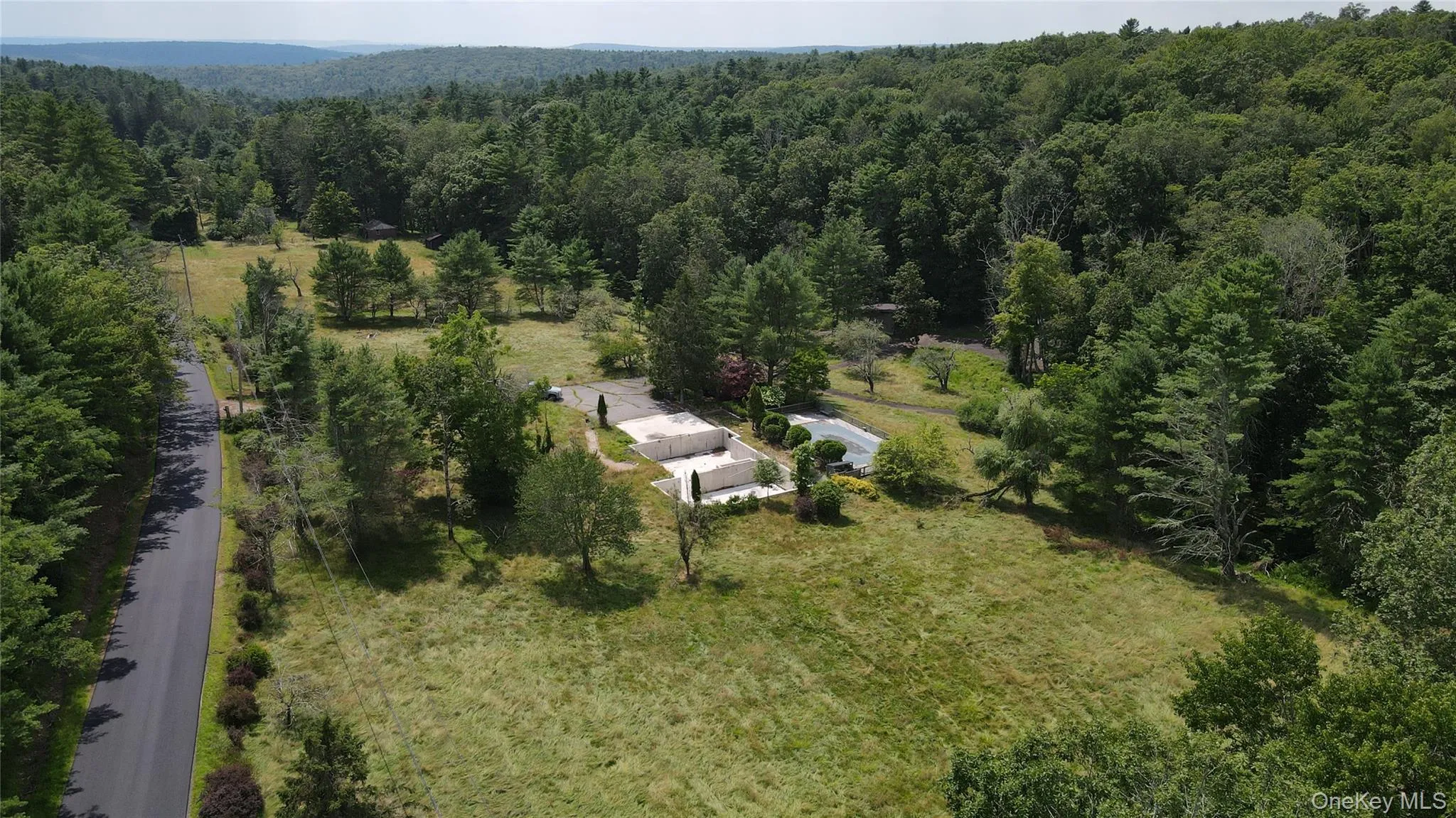 View from above of property with a heavily wooded area View from above of property with a heavily wooded area