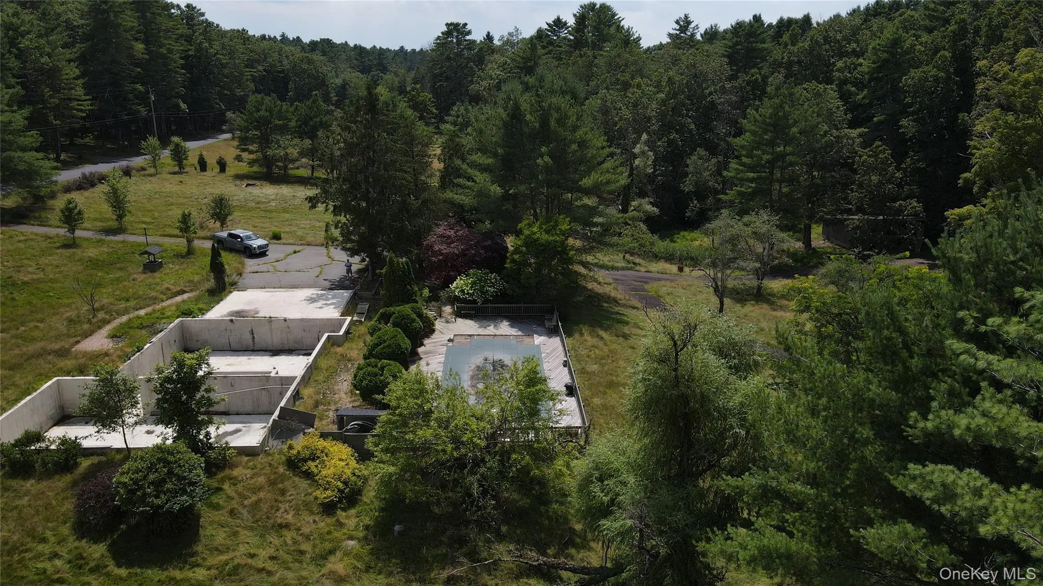 Aerial view of property and surrounding area featuring a heavily wooded area Aerial view of property and surrounding area featuring a heavily wooded area